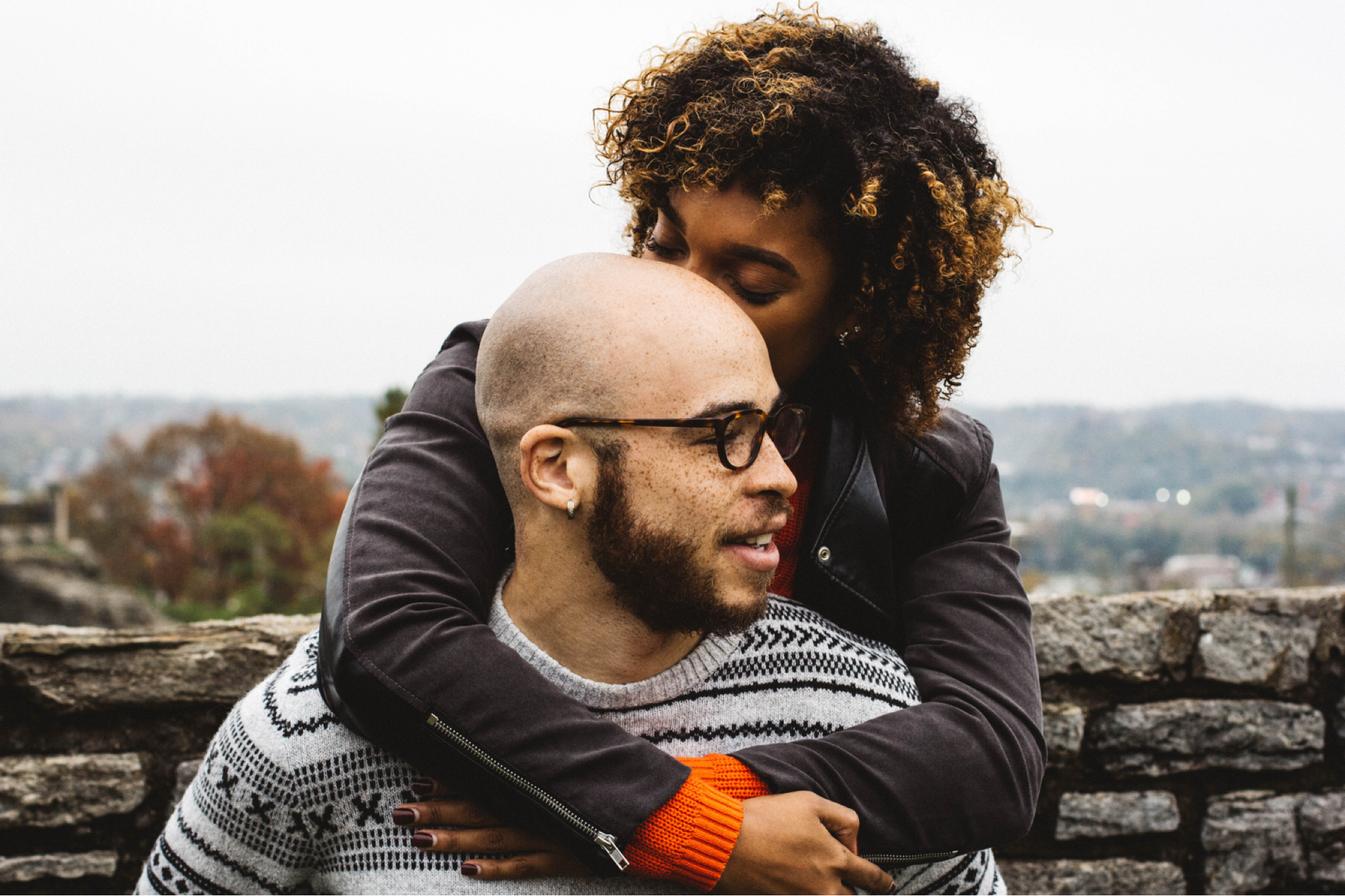 world suicide prevention day woman embracing man from behind on a cloudy day